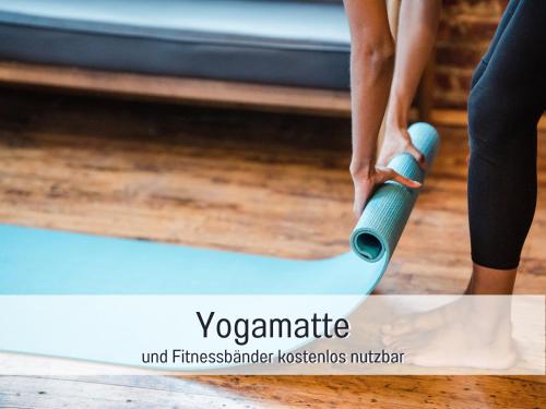 a woman is standing on a yoga mat at RamosHansenHof Fewo Fördebrise mit Sauna in Steinberg