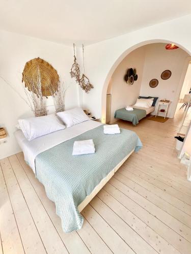 a bedroom with a large bed in a room at mills suites mykonos in Mýkonos City