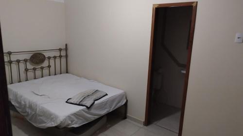 a small bedroom with a bed and a closet at Casa de Praia in Fundão