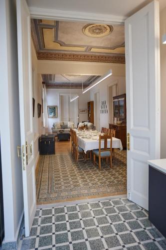 a dining room with a table and a living room at 1906 Citygarden in Chios