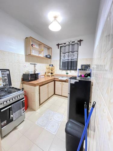 a kitchen with a stove and a counter top at MASKANI COSY APARTMENT - Nyali, Mombasa. in Mombasa