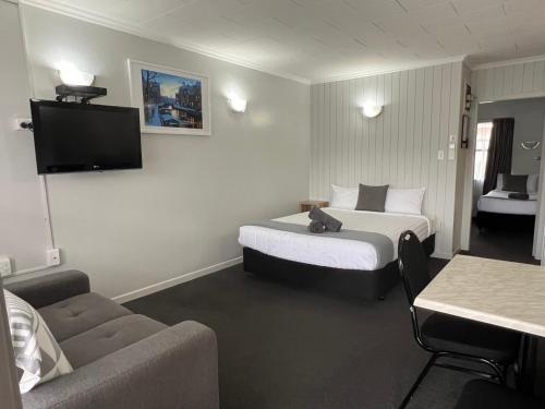 Postel nebo postele na pokoji v ubytování Kensington Motel