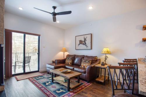 a living room with a couch and a table at River West Buffalo Mountain Condo: On The Blue River in Silverthorne