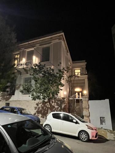 a white car parked in front of a building at 1906 Citygarden in Chios