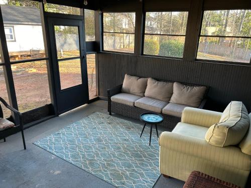 a living room with a couch and a table at The Treasure House in Smyrna