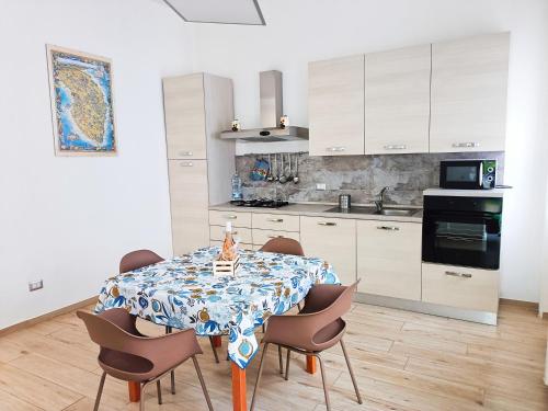 a kitchen with a dining room table with chairs at Casa Vergara Piazza Mazzini in Lecce