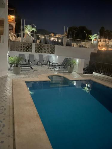 a view of a swimming pool at night at Villa Flores Mijas Fuengirola in Santa Fe de los Boliches