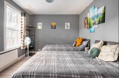 a bedroom with a bed and a couch at Hatton Homes - Thackeray Avenue in London