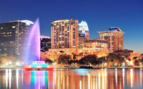 a city skyline with a fountain in the water at Bposhtels Orlando Disney in Kissimmee