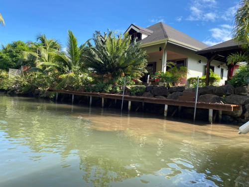 a house sitting next to a body of water at Villa Ora Na in Mahina
