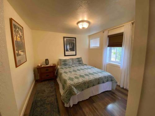 a small bedroom with a bed and a window at Zootown Bungalow in Missoula