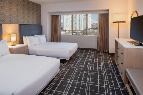 a hotel room with two beds and a large window at Doubletree Suites by Hilton Salt Lake City in Salt Lake City