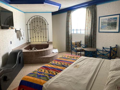 a hotel room with a bed and a bath tub at Hotel Oasis Acapulco in Acapulco