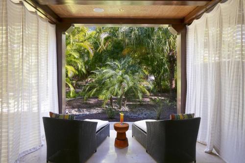 a screened porch with a view of a garden at JW Marriott Guanacaste Resort & Spa in Tamarindo