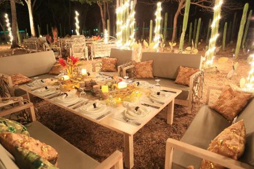 a table with plates and candles on top of it at JW Marriott Guanacaste Resort & Spa in Tamarindo