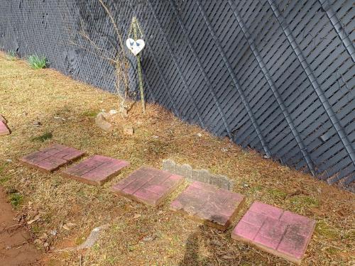 a walkway with a heart on it next to a fence at The Treasure House in Smyrna