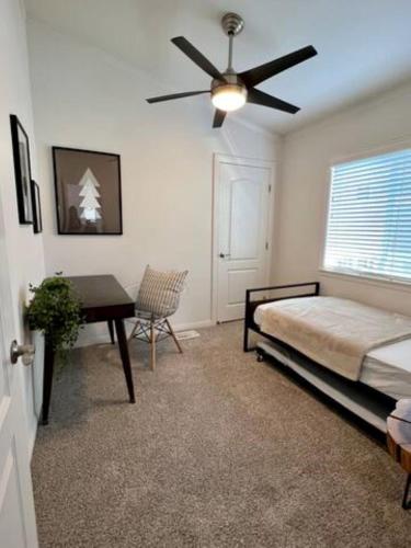 a bedroom with a bed and a ceiling fan at 3 Blocks to Todos Santos Prime Downtown Location in Concord