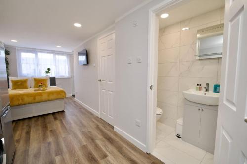 a white bathroom with a sink and a toilet at Dane Duplex Studio Two – Cosy Coventry Haven in Coventry