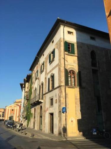 a large stone building on the side of a street at Romantic Suite in Pisa