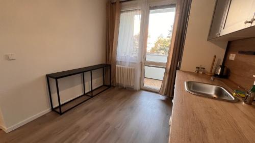 an empty kitchen with a sink and a window at Air conditioned 3 room apartment, near Technopol in Bratislava