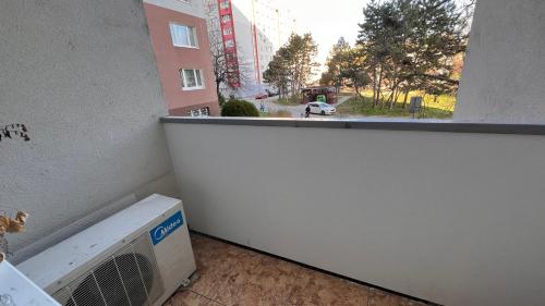 an apartment balcony with a air conditioner in a building at Air conditioned 3 room apartment, near Technopol in Bratislava