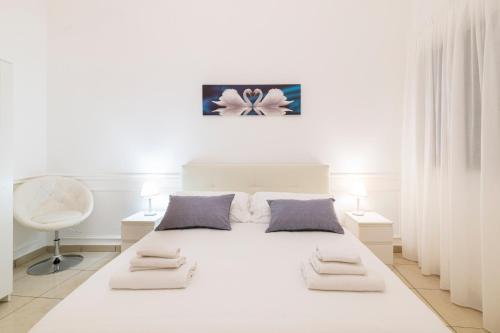ナポリにあるMontesanto Homeの白いベッドルーム(白いベッド1台、ランプ2つ付)