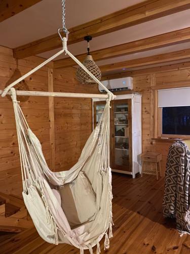 a hammock hanging from a ceiling in a room at Przystanek Tonkiele in Tonkiele