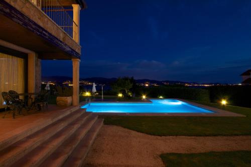 a swimming pool in a backyard at night at A Maquia in Poio
