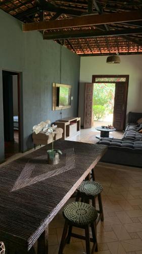 a living room with a large table and chairs at Village por do sol in Aracaju