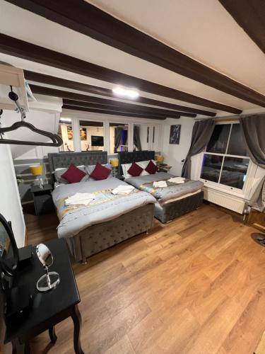 a large room with two beds and a couch at HELIN’s Cottage in Whitby