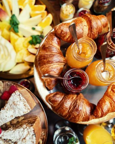 a plate of croissants and other pastries on a table at Hotel Pietryna in Łódź