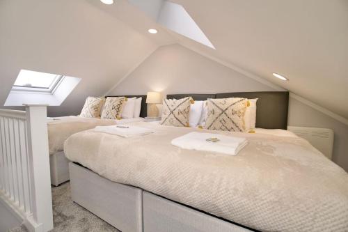 a bedroom with two beds in a attic at Dane Duplex Studio Six - Tranquil Coventry Getaway in Coventry