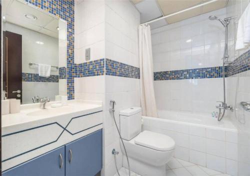 a bathroom with a toilet and a sink and a shower at Astonishing 1 Bedroom in Jumeirah Lake Towers in Dubai