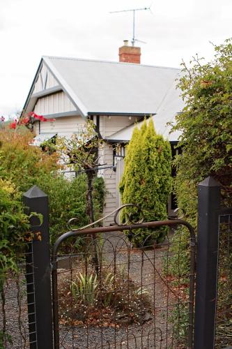 an iron gate in front of a house at Borough Country House in Korumburra