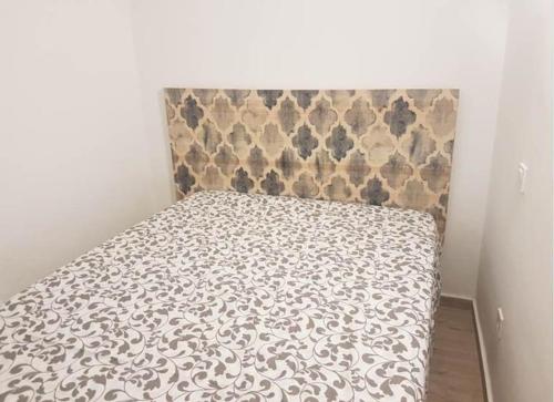 a bed in a room with a bedspread on it at Sebastian Elcano, apartamento para 2 con terraza, metro Embajadores in Madrid