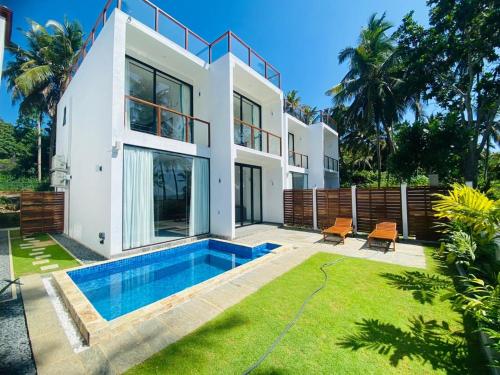 a house with a swimming pool in the backyard at Kaas Villas in Dickwella