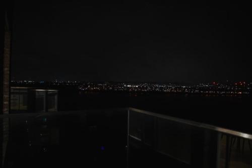 a view of a city at night at Top floor Apartment in London