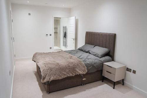 a bedroom with a bed and a dresser and a mirror at Top floor Apartment in London