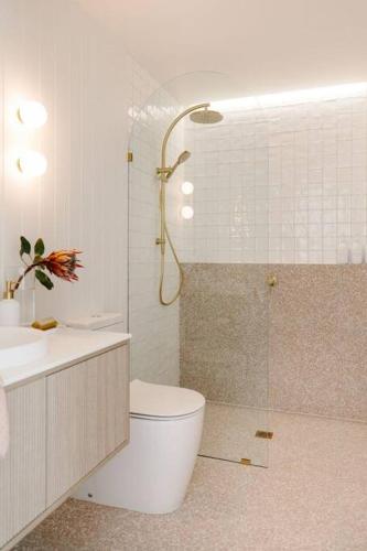 a bathroom with a toilet and a sink and a shower at Good Soul Cottage in Invermay