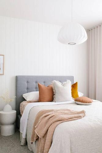 a bedroom with a bed with pillows on it at Good Soul Cottage in Invermay