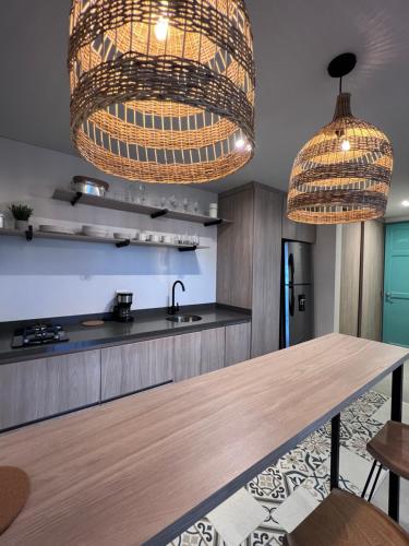 a kitchen with two hanging lights and a table at Parallelo Loft Salento P4 in Salento