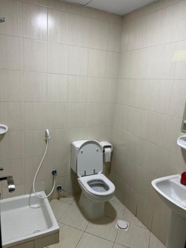 a bathroom with a toilet and a sink at F22R4 Small room attach bath at beach in Ajman 