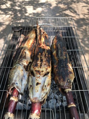 two pieces of food cooking on a grill at LA'S FARMSTAY in Trảng Bàng