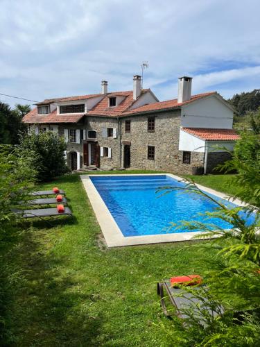 a house with a swimming pool in the yard at La coruña Sas playa y golf in Paderne