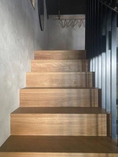 a set of wooden stairs in a room at The Base at Byron in Suffolk Park