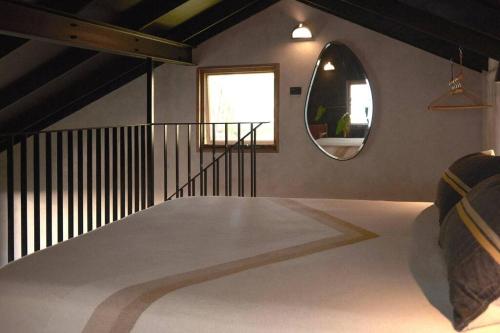 a room with a round mirror and a staircase at The Base at Byron in Suffolk Park