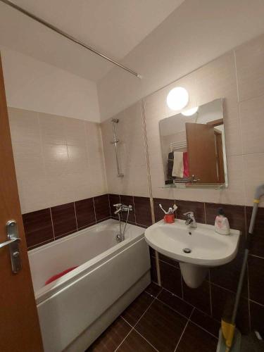 a bathroom with a tub and a sink and a bath tub at Art Studio Borovets Semiramida in Borovets