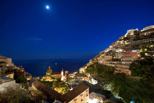 a view of a city at night at Hotel Savoia in Positano