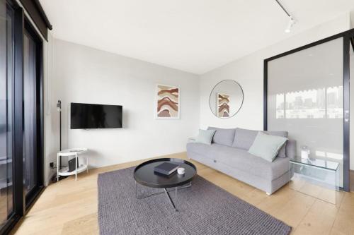 a living room with a couch and a table at City Views in a Railway Escape in Melbourne