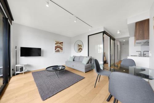 a living room with a couch and a table at City Views in a Railway Escape in Melbourne